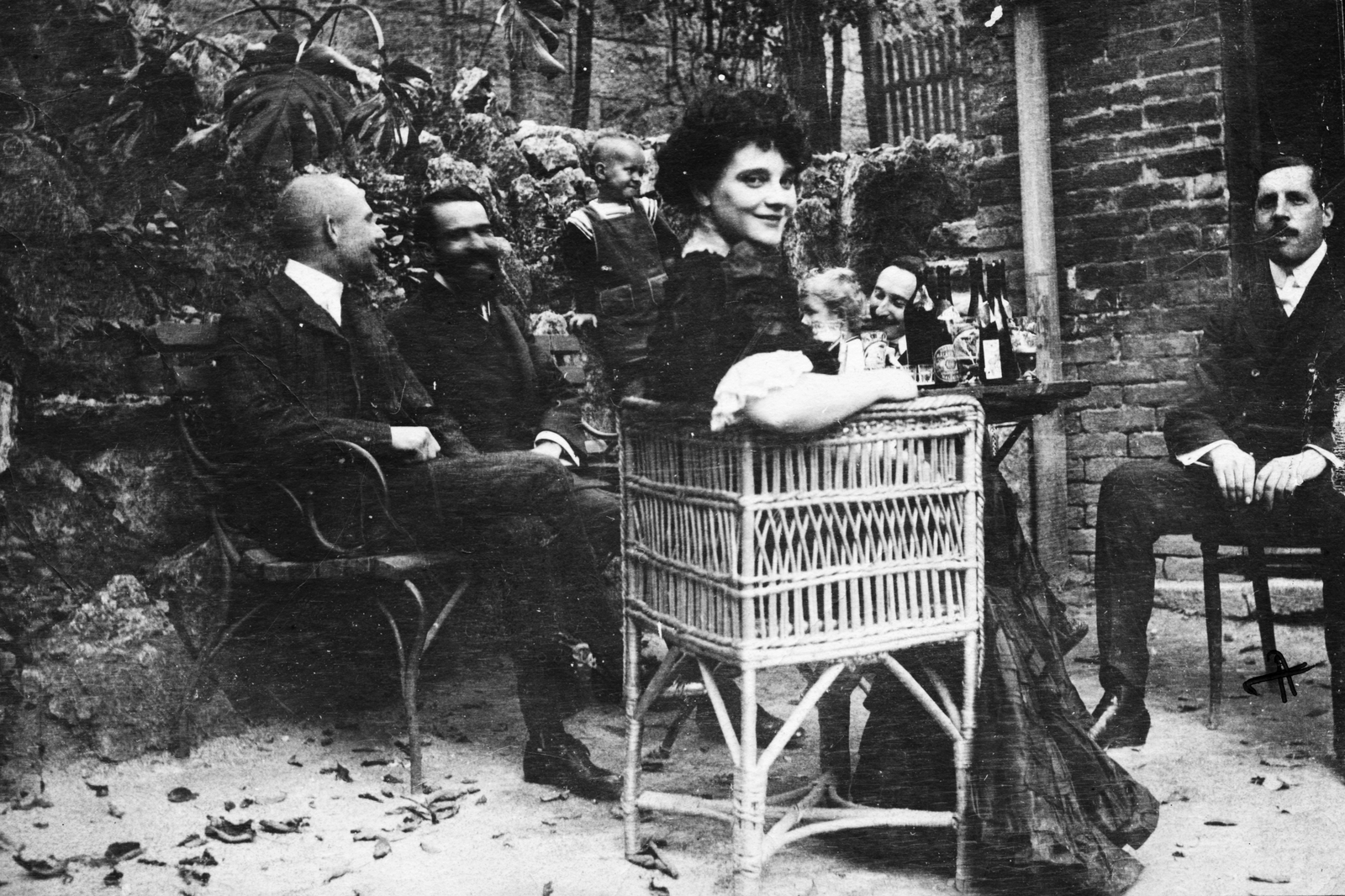 Magyarország, előtérben Medgyaszay Vilma, jobbra Magyar Elek újságíró, gasztronómiai szakíró., 1910, Magyar Bálint, udvar, fonott szék, csoportkép, bútor, italozás, sör, pad, pohár, társaság, borosüveg, sörösüveg, visszanézés, Fortepan #55373