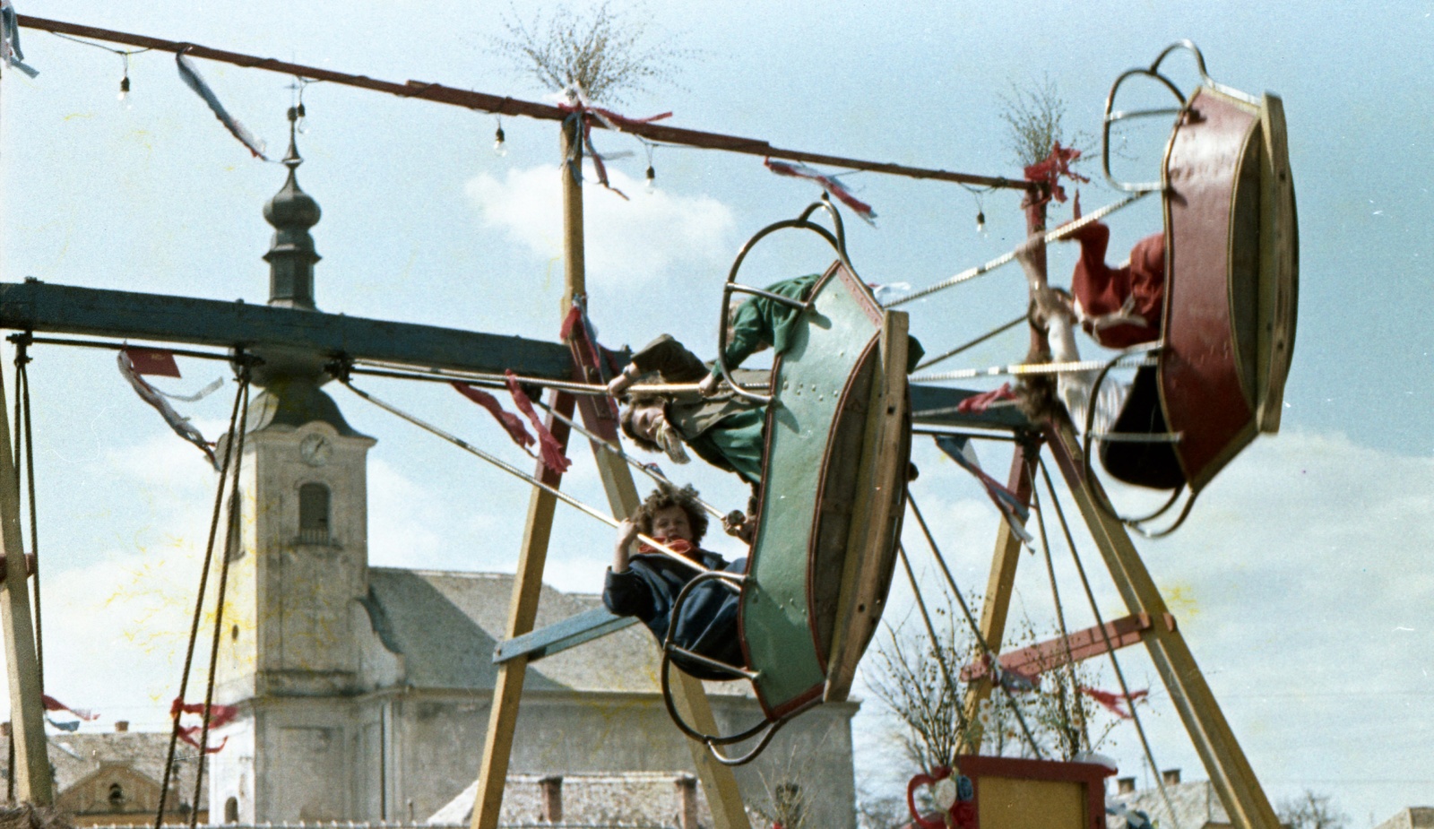 Slovakia, Poltár, Námestie 1. mája, háttérben az evangélikus templom., 1958, Zsanda Zsolt, Vajszada Károly, Czechoslovakia, church, colorful, swing-boat, Fortepan #60217