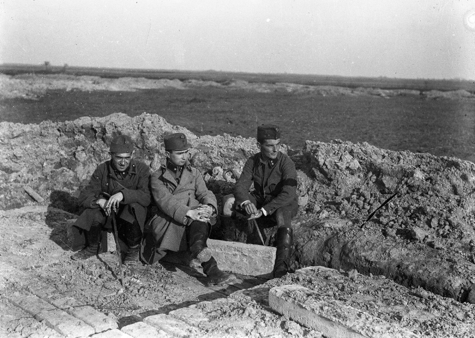 1915, Veszprém Megyei Levéltár/Klauszer, First World War, soldier, armband, sitting with hands on knees, leg over leg, intertwined fingers, Fortepan #62724