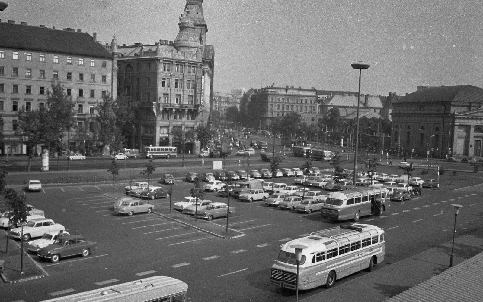 Magyarország, Budapest V.,Budapest VI., Erzsébet (Engels) tér, parkoló a MÁVAUT autóbusz-pályaudvar előtt. Szemben az Anker-ház, jobbra az evangélikus templom a Deák Ferenc téren. Távolabb a Károly (Tanács) körút épületsora látható., 1966, Magyar Rendőr, városkép, Ikarus-márka, parkoló, Ikarus 55, Ikarus 66, lámpaoszlop, Wartburg 311/312, Opel Rekord P1, Budapest, Fortepan #65389