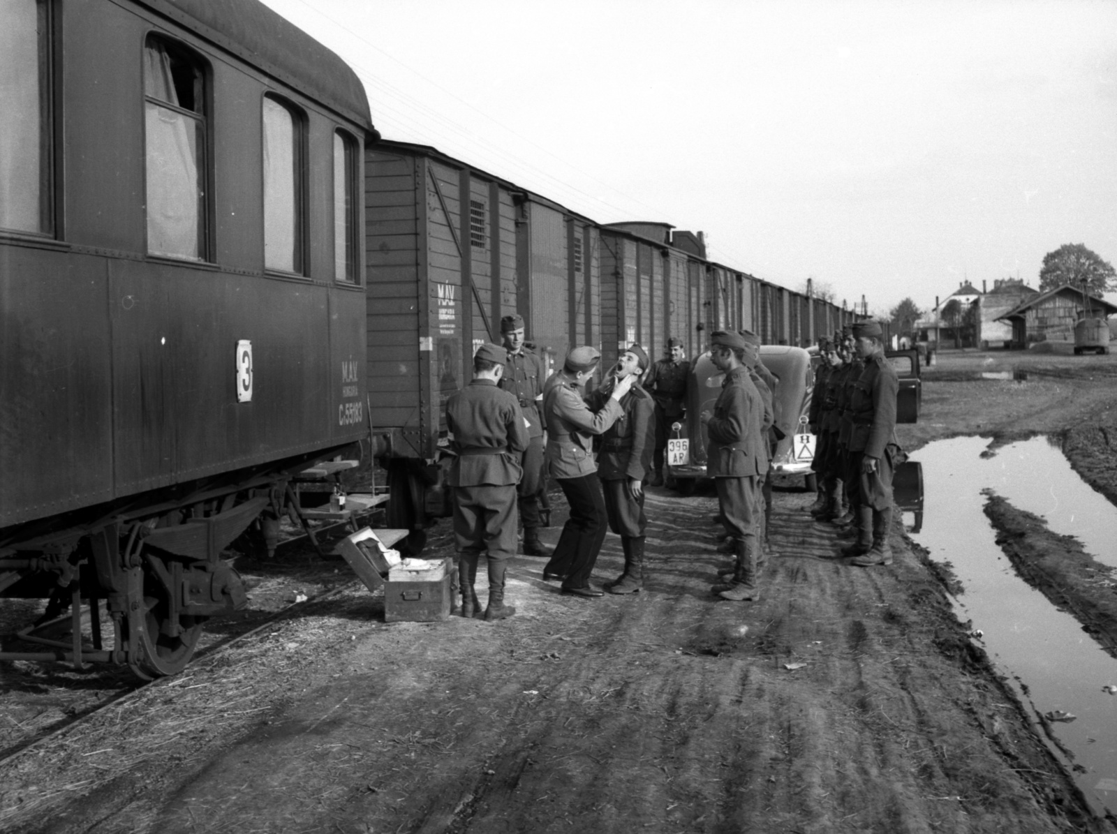 Croatia, Beli Manastir, vasútállomás., 1941, Lissák Tivadar, Hungarian Railways, puddle, rail, soldier, train station, mud, chest, automobile, number plate, board, physical examination, Fortepan #71558