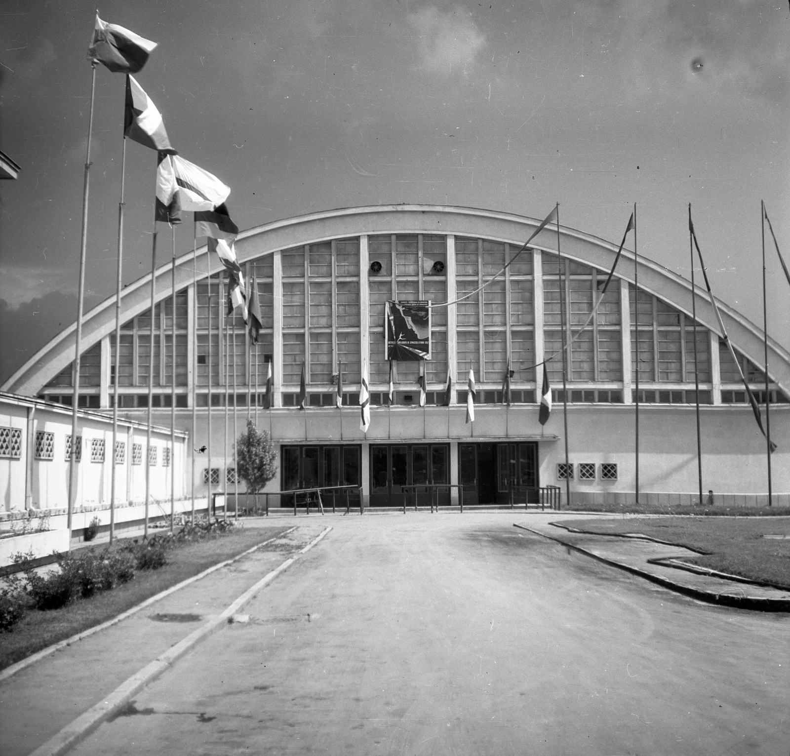 Romania, Bucharest, Floreasca sportcsarnok a Strada Aviator Popa Marin felől nézve. Az I. női torna Európa-bajnokság helyszíne, 1957. május 27-28., 1957, Romák Éva, flag, sport hall, Fortepan #75066