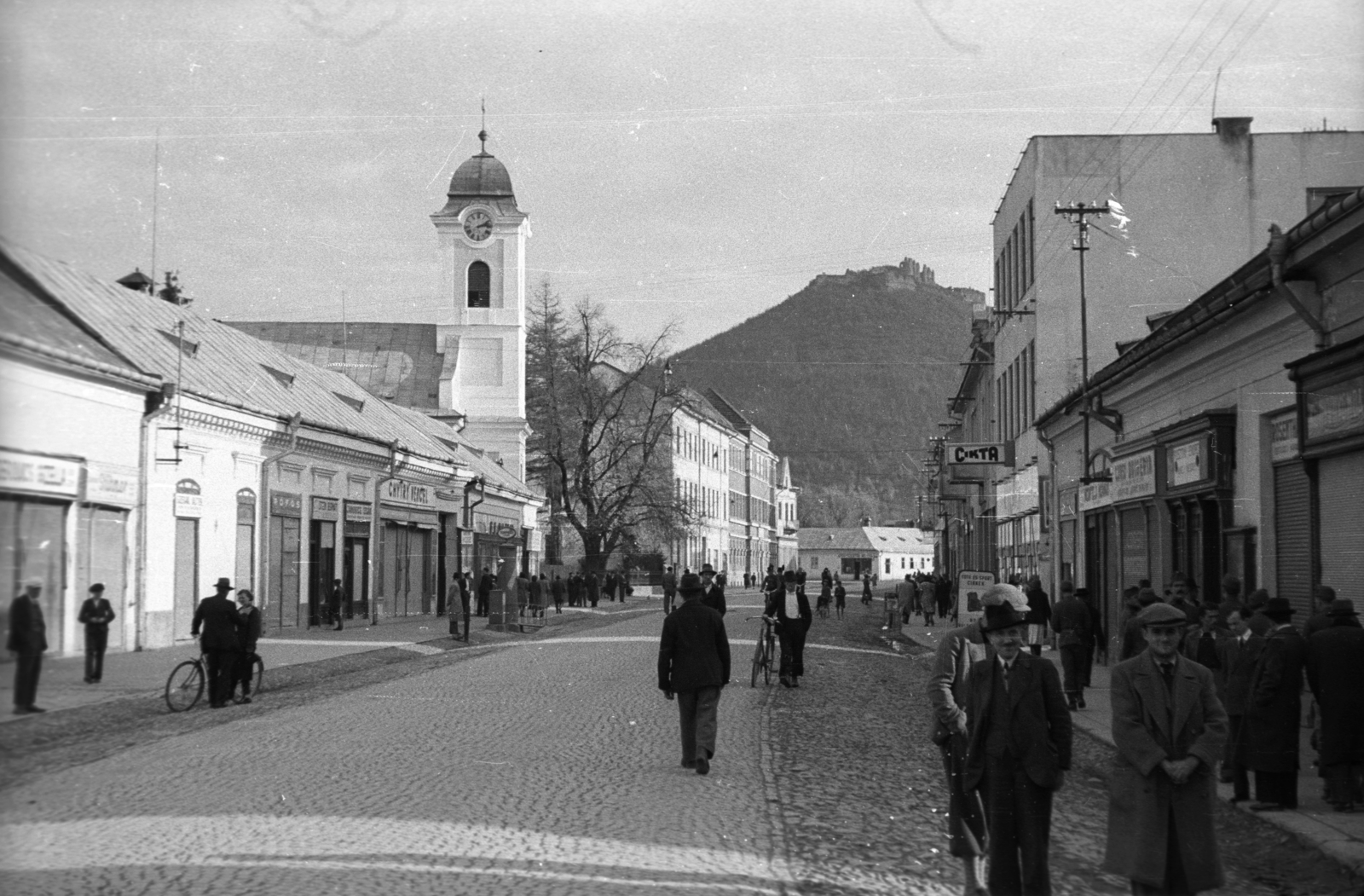 Ukraine,Zakarpattia Oblast, Khust, Karpatszkoji Szicsi utca (Rákóczi út) a főtér felől nézve, balra a Szent Anna-templom, háttérben a vár., 1939, Berkó Pál, church, street view, ruins, castle ruins, Fortepan #78505
