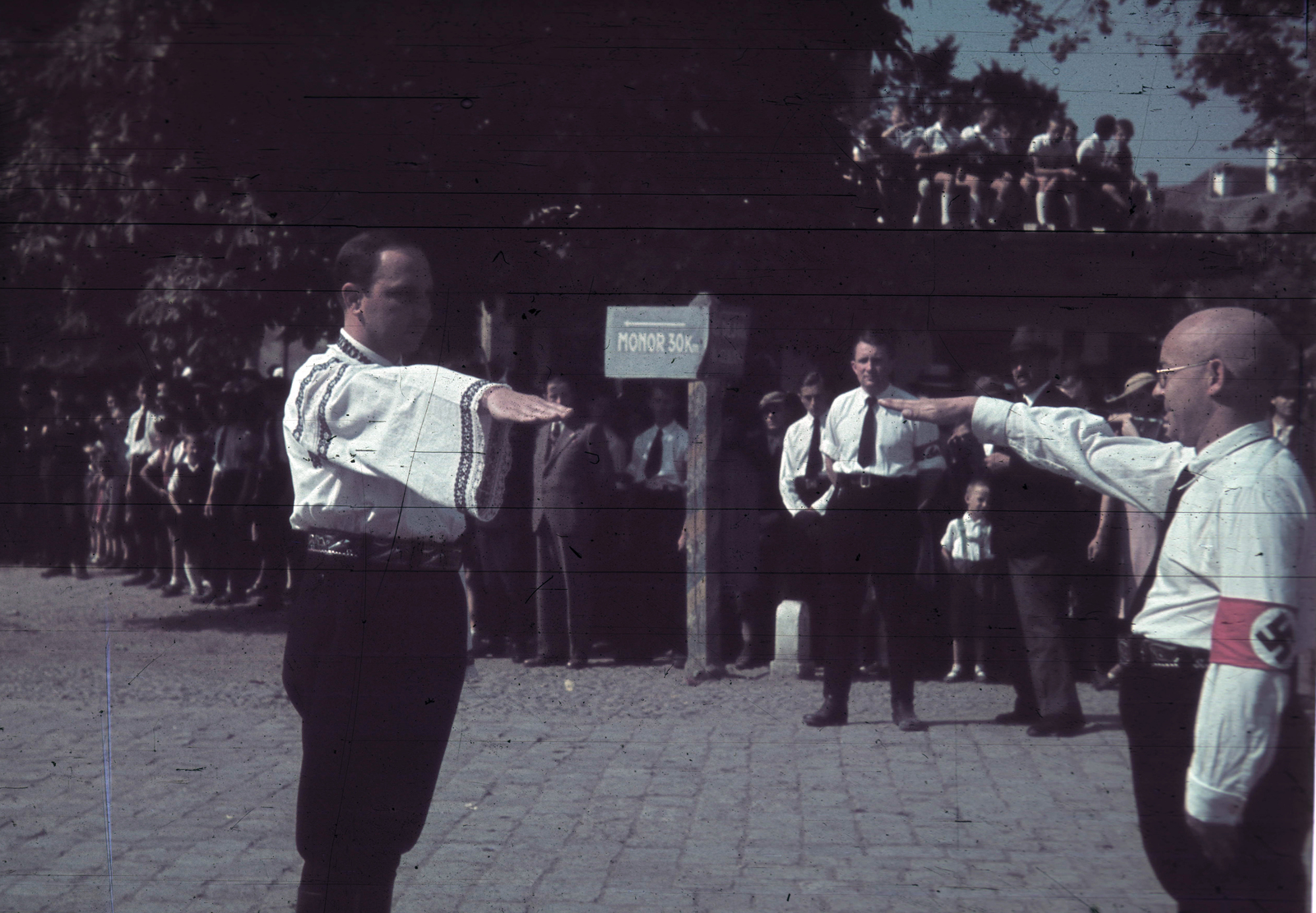 Romania,Transylvania, Bistrița, Fő tér (piata Centrala, ekkor Horthy Miklós tér) az evangélikus templom előtt a magyar csapatok bevonulása idején. A felvétel 1940. szeptember 8-án készült., 1940, Fortepan, territorial gain, colorful, road signs, swastica, posture, armband, Fortepan #92536