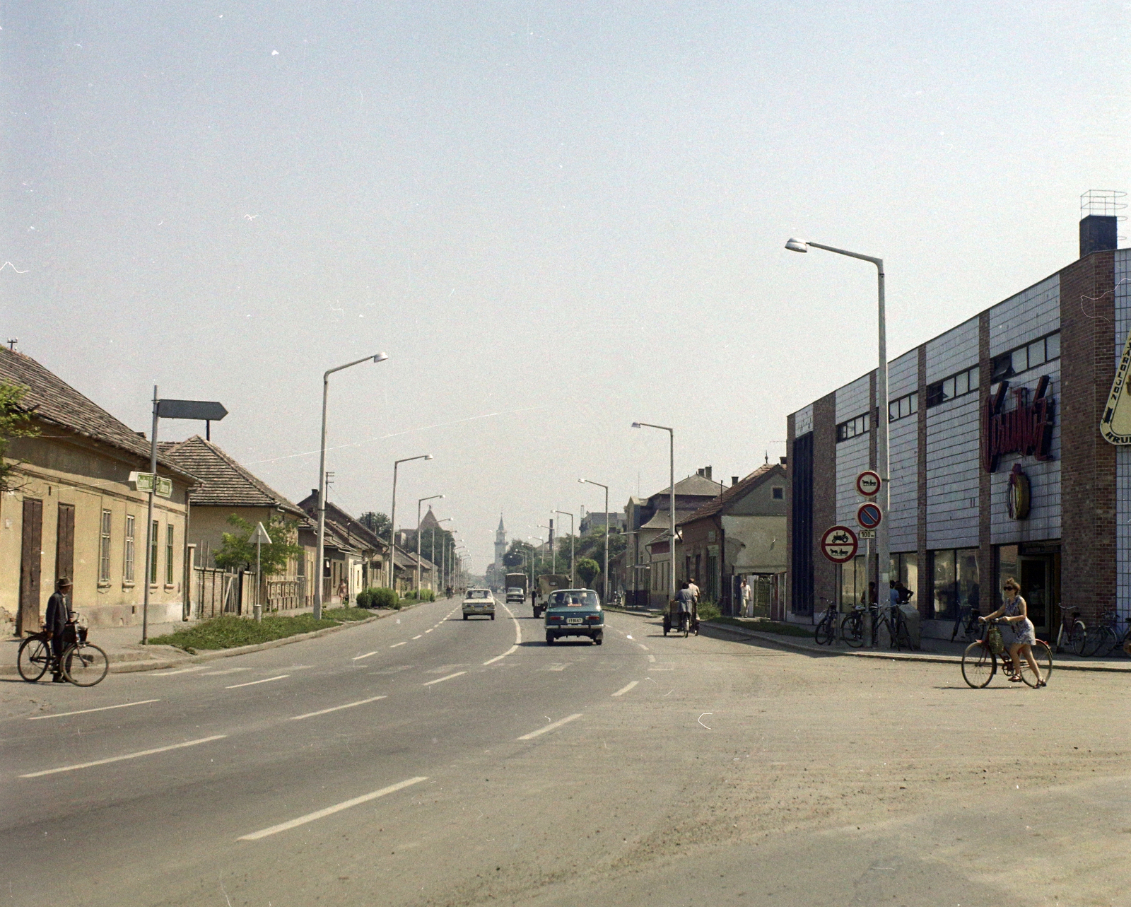 Magyarország, Törökszentmiklós, Kossuth Lajos utca a Pánthy Endre út saroktól nézve, távolban a református templom., 1974, UVATERV, színes, kerékpár, Fortepan #99353