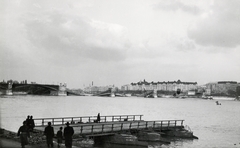 Magyarország, Budapest II.,Budapest XIII., a lerombolt Magit híd a budai alsó rakpartról nézve, előtérben egy komp., 1944, Archiv für Zeitgeschichte ETH Zürich / Agnes Hirschi, Carl Lutz, háborús kár, járműroncs, hídroncs, bámészkodás, ponton, hajódaru, Budapest, Fortepan #105727