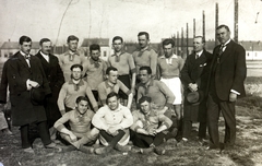 Hungary, Kaposvár, a felvétel a későbbi Kaposvári Városi Sporttelepen készült, háttérben a Hunyadi János utca házsora, 1914, Schmal Alexandra, soccer team, cross-legged sitting, hat in hand, Fortepan #115591