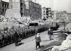 Ukrajna, Kijev, a Hrescsatik sugárút felrobbantott épületei, a kép bal szélén a Gyetszkij Mir (Gyermekvilág) áruház romjai., 1943, Marics Zoltán, második világháború, épületkár, menetoszlop, Fortepan #131344