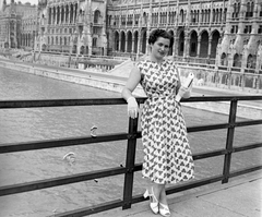 Magyarország, Budapest, Kossuth híd, háttérben a Parlament., 1955, Kurutz Márton, portré, kesztyű, Steindl Imre-terv, retikül, hölgy, országház, neogótika, Duna, szandál, eklektikus építészet, nyári ruha, Fortepan #16374