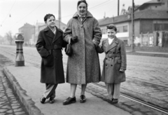 Magyarország, Budapest XI., Bartok Béla út, Karolina út villamosmegálló, háttérben a páratlan oldal a Kelenföldi pályaudvar felé., 1958, Divéky István, villamosmegálló, Budapest, csibilámpa, anya, kabát, fiúk, Fortepan #183861