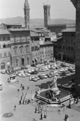 Olaszország, Firenze, Piazza della Signoria, előtérben a Neptun kút, balra I. Cosimo de’ Medici lovas szobra, háttérben a Badia Fiorentina apátság, jobbra a Bargello-palota (Bargello Nemzeti Múzeum). A felvétel a Loggia dei Lanzi-ról készült., 1965, Aradi Péter, Szenczi Mária, torony, szökőkút, parkoló, madártávlat, szobor, Fortepan #212173