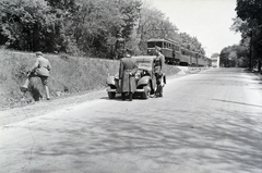 Hungary, Gödöllő, a Szabadság út (3-as főút) a HÉV Erzsébet park megállójánál., 1944, Reményi József, Hungarian soldier, flat tyre, commuter train, Fortepan #258098