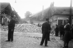 Szlovákia, Kassa, Bethlen Gábor körút (Kuzmányho ulica)-i házak az 1941. június 26.-i bombázás után. A romos ház helyén nyitották a Vojenská ulica-t., 1941, Reményi József, plakát, épületkár, kerékpár, magyar katona, rendőr, tűzfal, tejivó, kávémérés, kerékpáros rendőr, Fortepan #258814