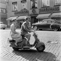 Németország, Marburg, Bahnhofstrasse, háttérben a 14. számú épület., 1958, UWM Libraries, Eugene Vernon Harris, Best of, áruház, NSZK, képarány: négyzetes, fiatalság, árnyékoló, robogó, motorkerékpár, automobil, Fortepan #259325