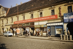 Slovakia, Bratislava, Szlovák Nemzeti Felkelés tere / Námestie SNP (egykor Vásár tér, ekkor Sztálin tér), az irgalmas rend egykori épülete, kissé a Posta utca (ulica Postova) felé fényképezve., 1960, UWM Libraries, shoe store, colorful, Moskvitch-brand, movie poster, label, store, dustbin, shutter, dairy, Fortepan #260583