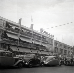 Németország, Berlin, Hardenbergstrasse 29, Haus Germania, jobbról a második autó egy Tatra T77., 1936, Lőrincze Judit, csehszlovák gyártmány, Tatra-márka, neonreklám, horogkereszt, Tatra 77, metró, Fortepan #26148