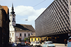 Hungary, Baja, Vörösmarty Mihály utca, jobbra a Bácska Áruház. Távolabb a Szent Imre téren a Szent Péter és Pál apostolok-templom., 1983, Lorkó Fanni, number plate, colorful, Fortepan #263274