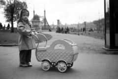 Magyarország, Budapest V., a felvétel a Fővám (Dimitrov) téren készült, háttérben a Szabadság híd., 1958, Horváth József, Budapest, ballonkabát, kislány, babakocsi, Fortepan #265762