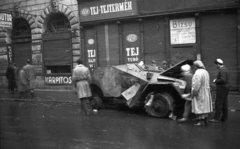 Magyarország, Budapest VII., Akácfa utca, kiégett szovjet BTR-40 páncélautó a 3. számú ház előtt, balra az 5-ös számú ház látható., 1956, Nagy Gyula, cégtábla, szovjet gyártmány, páncélautó, forradalom, járműroncs, bizsu, kárpitos, harcjármű, BTR 40, Budapest, élelmiszerbolt, Közért Vállalat, Fortepan #40098