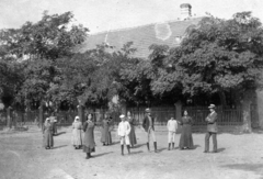 1914, Kafka Éva, hat, village, street view, folk costume, peasant, shorts, headscarf, knee socks, hands behind the back, arms crossed over the chest, Fortepan #40755