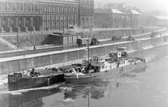 Magyarország, Budapest IX., pesti alsó rakpart és a Matróz csárda a Szabadság hídról nézve. Háttérben a Marx Károly Közgazdaságtudományi Egyetem (később Corvinus Egyetem) épülete., 1958, Fortepan, hajó, tél, teherautó, uszály, vontatóhajó, jégzajlás, Vác hajó, Budapest, autómentő, Fortepan #4318