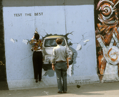 Germany, Berlin, Mühlenstrasse, a berlini fal (East Side Gallery), Birgit Kinder alkotása: Test the Best., 1990, Urbán Tamás, colorful, Trabant-brand, GDR, Berlin Wall, East-Berlin, wall painting, modern art, Fortepan #45319