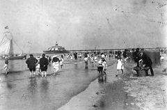 Hollandia, Hága, Scheveningen, háttérben a Vilma királynő móló., 1917, Vargha Zsuzsa, strand, vitorláshajó, zászló, tenger, sokaság, háttal, tengerpart, szélfogó fülke, Fortepan #47269