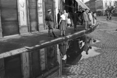 Hungary, Miskolc, Városház tér, jobbra az Erzsébet (Szabadság) tér sarka., 1955, Nagy Gyula, reflection, uniform, sign-board, puddle, street view, cobblestones, peaked cap, Fortepan #50403