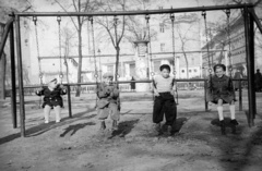 Hungary, Budapest V., Petőfi tér, háttérben a Dunakert a Duna Szálló déli falánál., 1955, Nagy Gyula, swing, tableau, ad pillar, kids, Budapest, Fortepan #51768