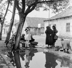 Slovakia, Fiľakovo, ulica Trhova (Piac utca)., 1959, Zsanda Zsolt, Vajszada Károly, Czechoslovakia, bicycle, market, puddle, vendor, basket, reflection, Fortepan #53774