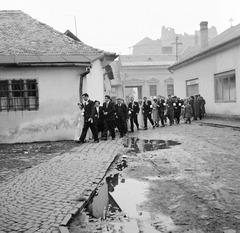 Slovakia, Fiľakovo, ulica Rázusova, háttérben a vár., 1959, Zsanda Zsolt, Vajszada Károly, Czechoslovakia, wedding ceremony, puddle, castle ruins, cobblestones, window bars, Fortepan #53798