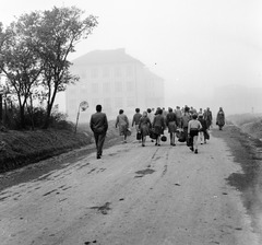 Szlovákia, Poltár, ulica Skolská (ekkor névtelen), balra az iskola., 1960, Zsanda Zsolt, Vajszada Károly, Csehszlovákia, iskola, buszmegálló, iskolatáska, köd, Fortepan #53987