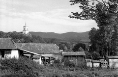 Magyarország, Perőcsény, háttérben a református templom tornya., 1988, Hodosán Róza, falu, templom, látkép, hegyoldal, istálló, ól, kukoricagóré, gazdaság, Fortepan #61594