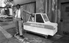 Hungary, 1985, Magyar Rendőr, portrait, yard, jesting, man, police vehicle, ad truck, pedal car, Fortepan #67152