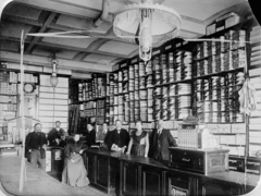 Hungary, Sopron, Várkerület 62., Jány Ferenc boltja., 1900, Library of Congress, tableau, women, men, vendor, interior, chandelier, fabrics, cash register, shop interior, Fortepan #77128