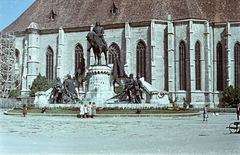 Románia,Erdély, Kolozsvár, Fő tér, Hunyadi Mátyás emlékműve, háttérben a Szent Mihály-templom., 1958, Császy Alice, színes, szobor, Mátyás király ábrázolás, Fortepan #85178